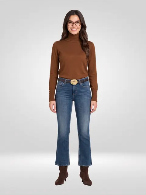 Brown turtleneck, cropped flare jeans with a brass belt and suede boots